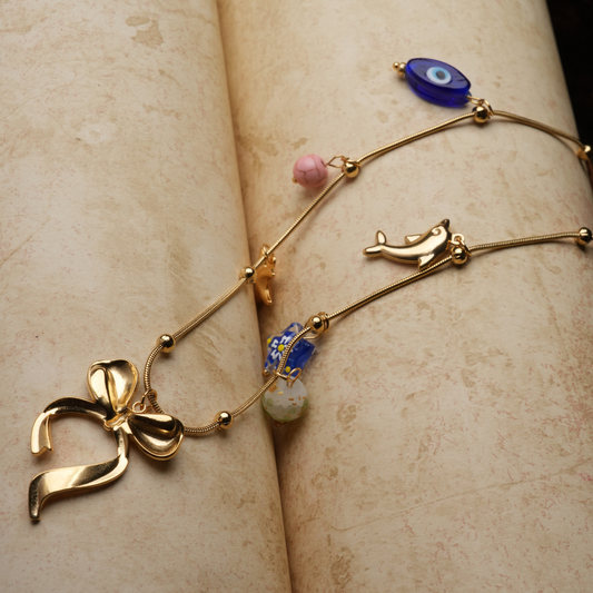 Gold-Tone Charm Necklace with Bow and Enamel Accents